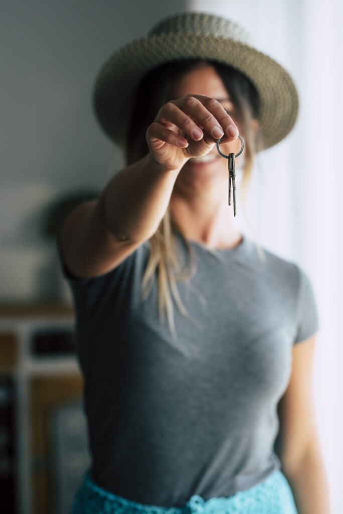 referral club - Portrait of female tenant renter show praise house keys moving to first own new apartment or house